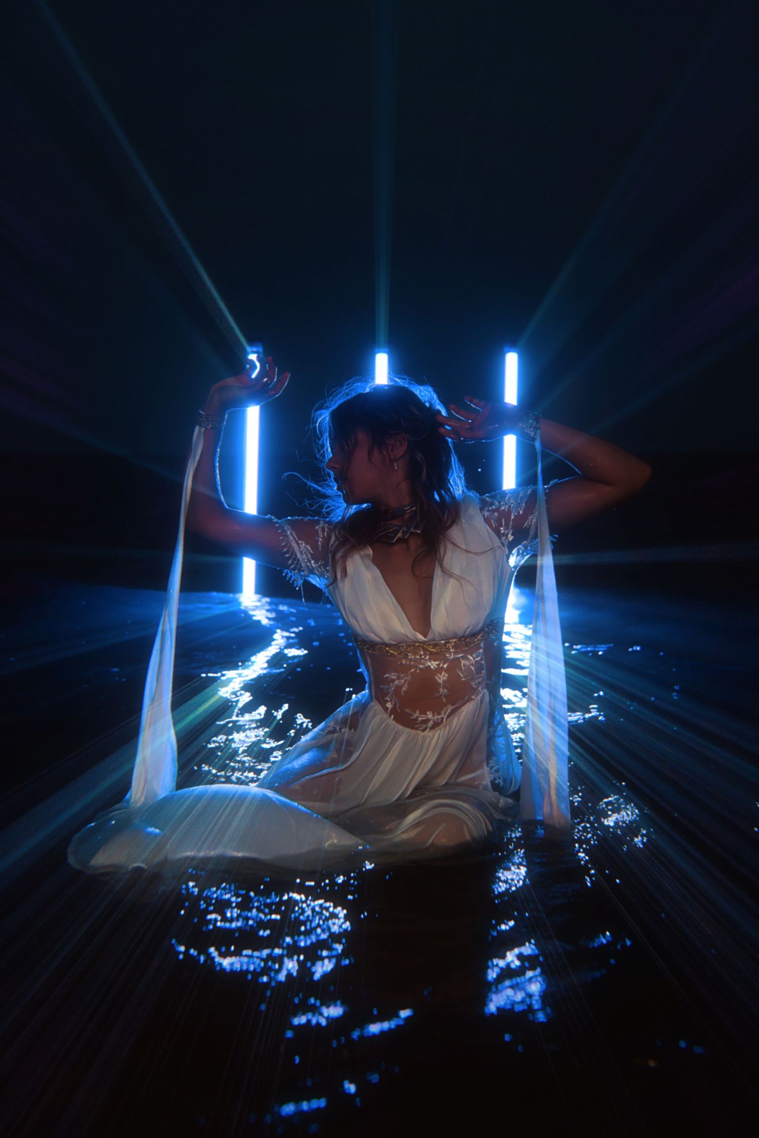 Artistic nighttime scene with glowing blue light sabers and twinkling lights creating a magical atmosphere.