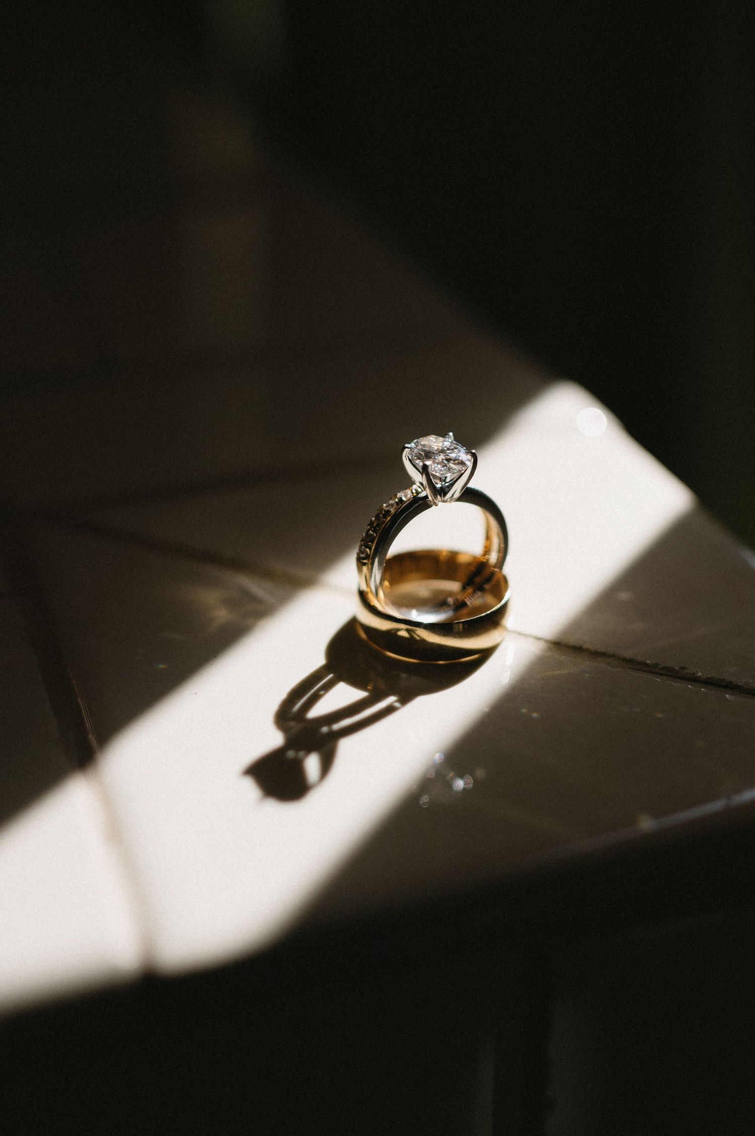 A diamond engagement ring casting dramatic shadows in progressive lighting angles, forming an artistic sequence.