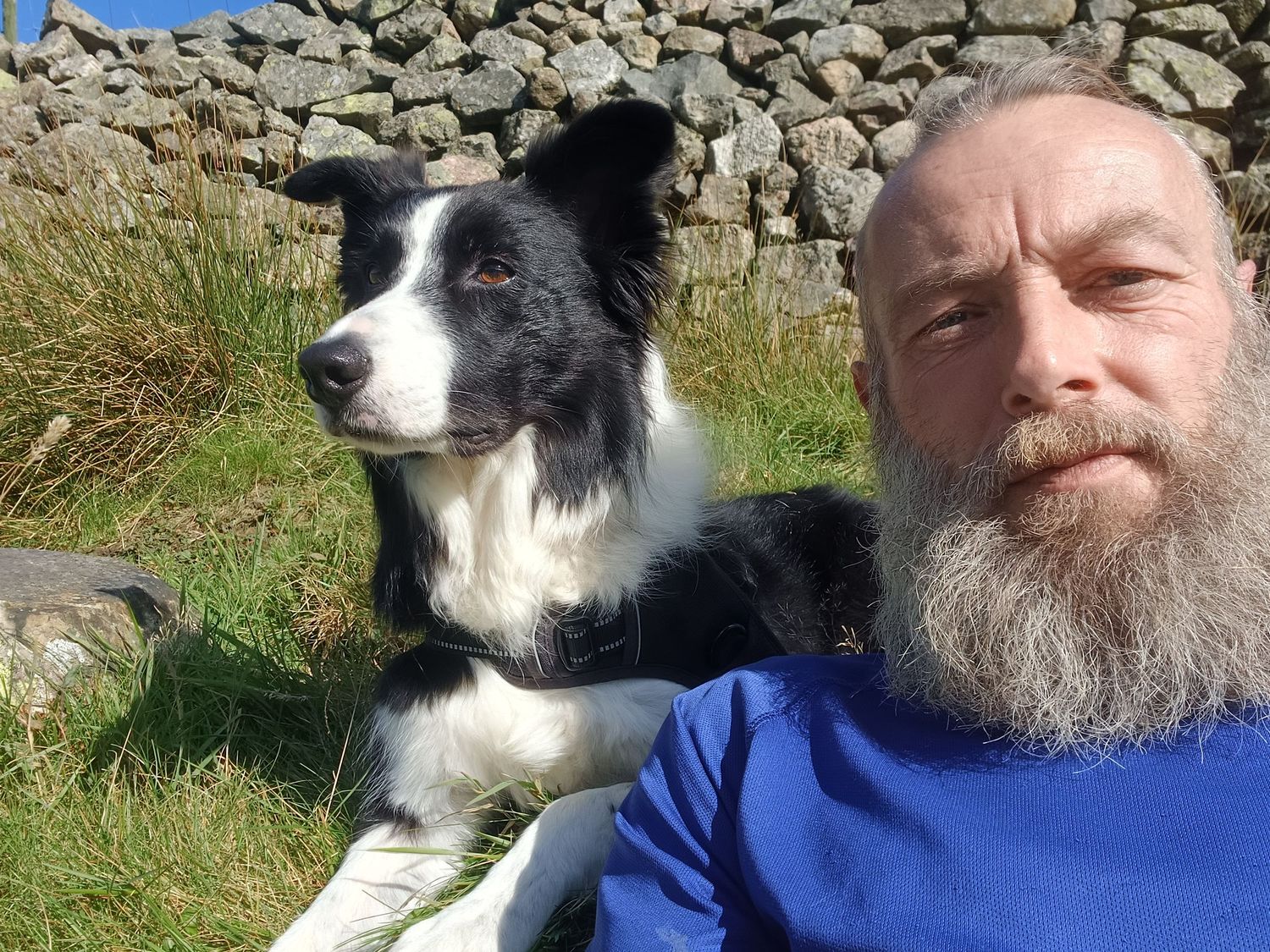 a photo of Mark Gamblin lying on the floor, owner of 4Ever Paw Prints Pet Photography, and with his border collie Scott