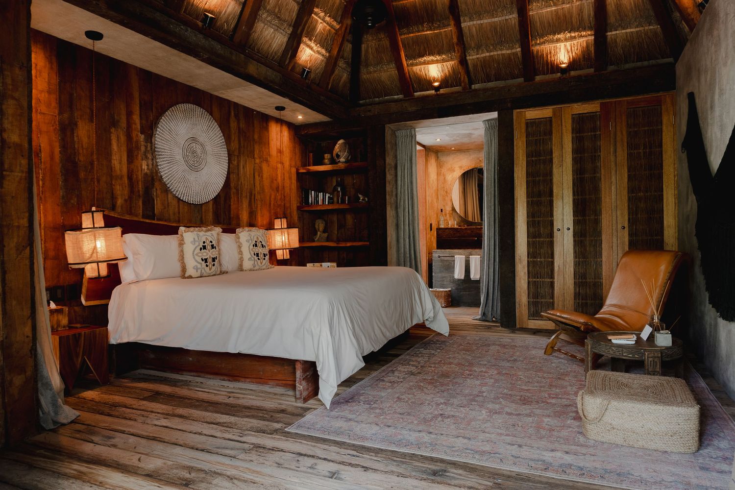 Rustic wooden cabin interior with warm lighting showcases a cozy bedroom space with exposed beams and natural textures.