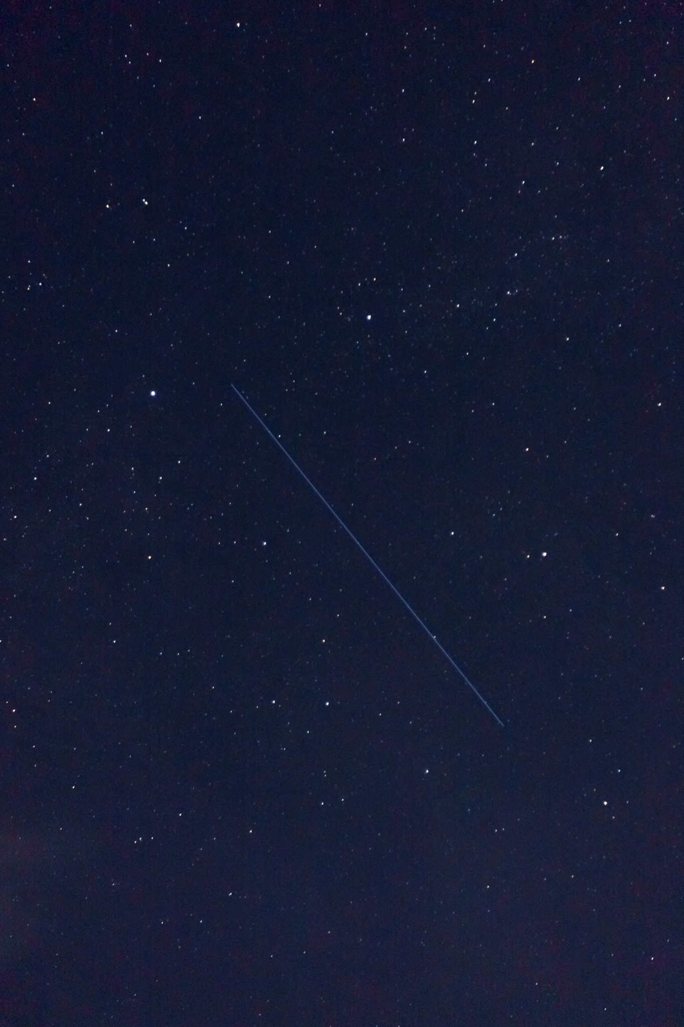 A time-lapse sequence showing a bright meteor streak across a starry night sky.