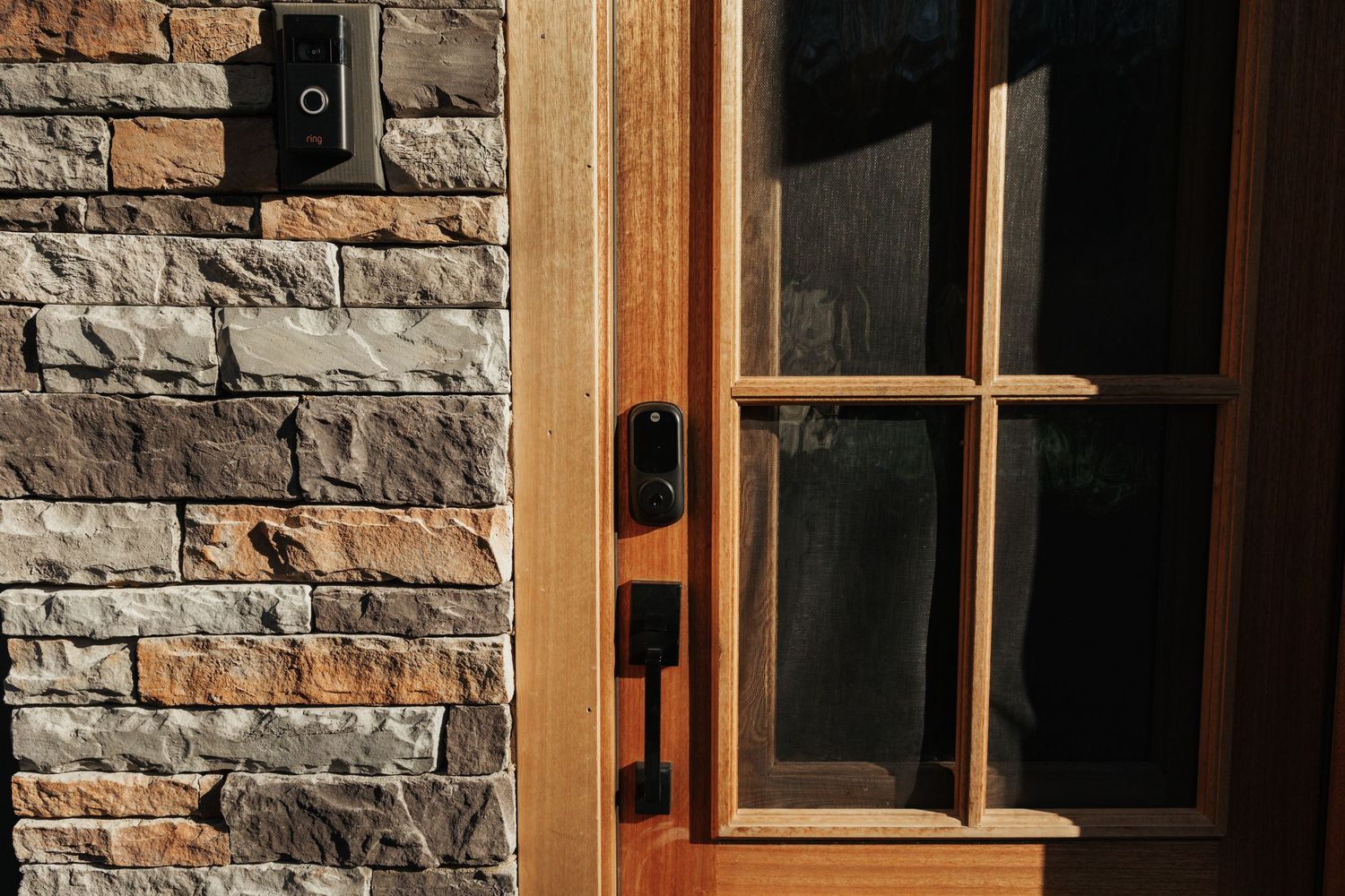 Close-up of a wooden front door and exterior stonework.