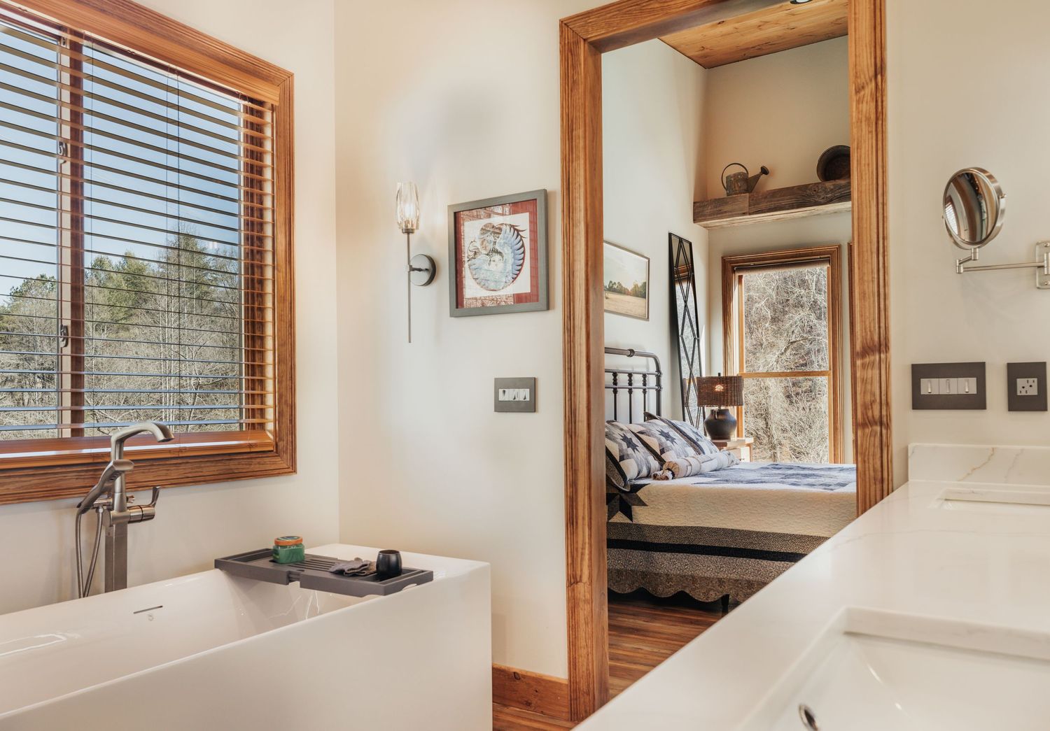 Main bathroom showing vanity and bathtub with a doorway leading to the bedroom.