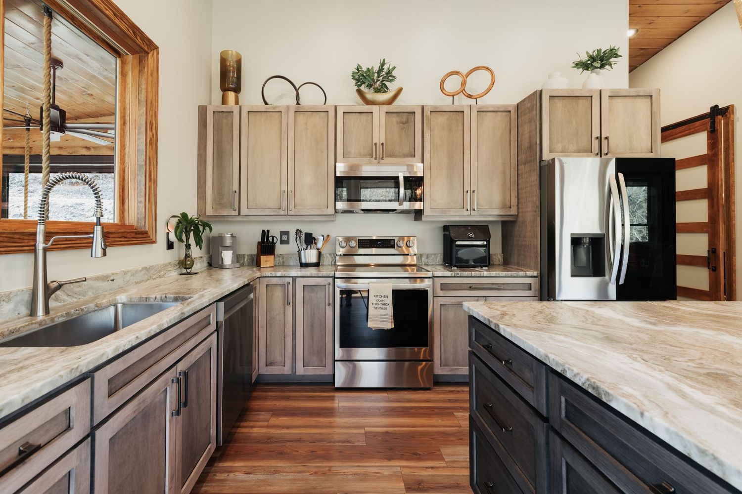 Gray cabinet kitchen with stainless steel appliances.