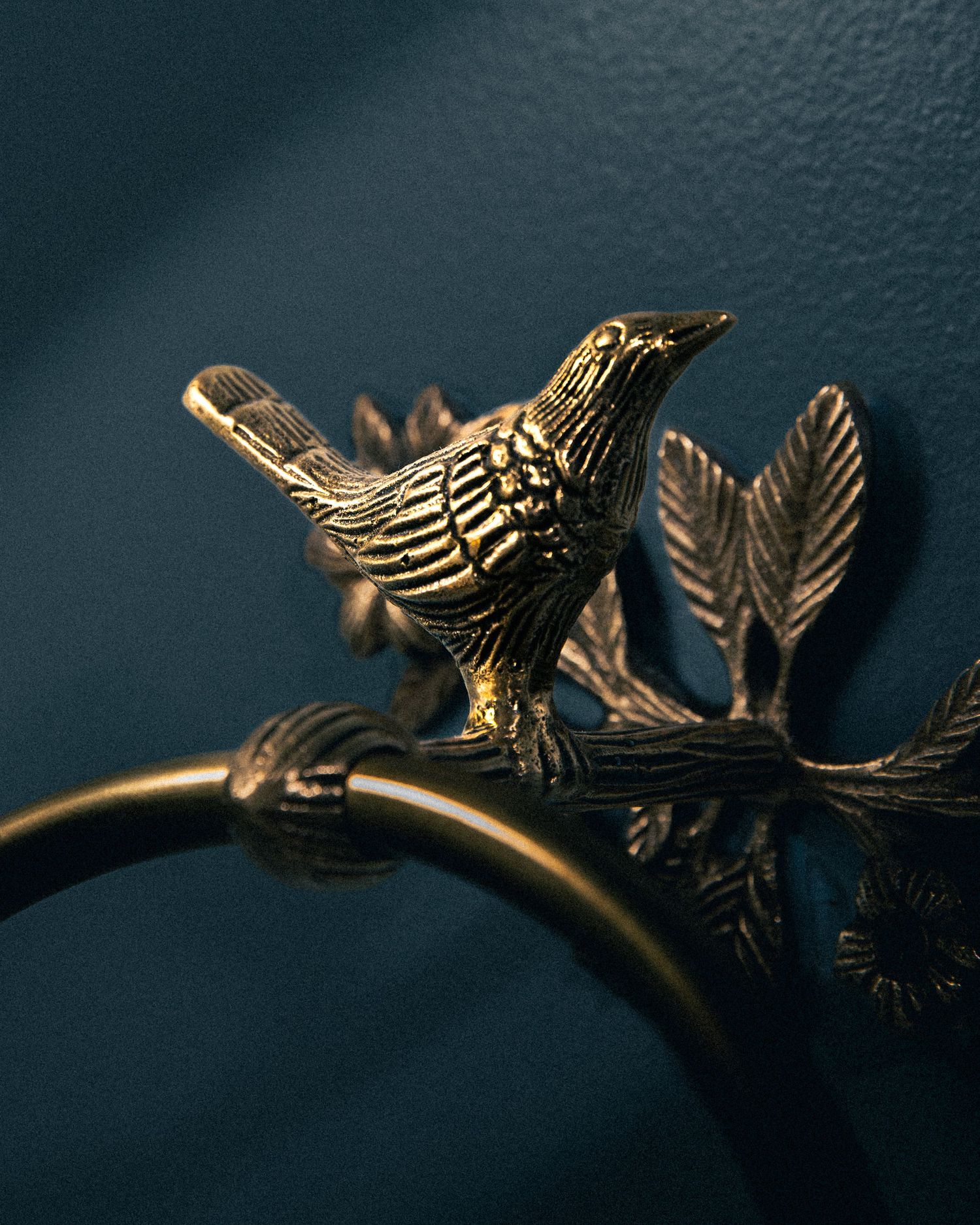bird brass hardware on darkblue background