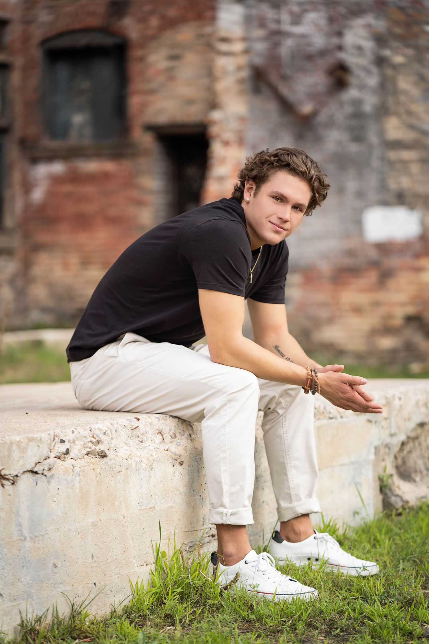 ndustrial senior photo session for guys with textured brick and urban vibes.