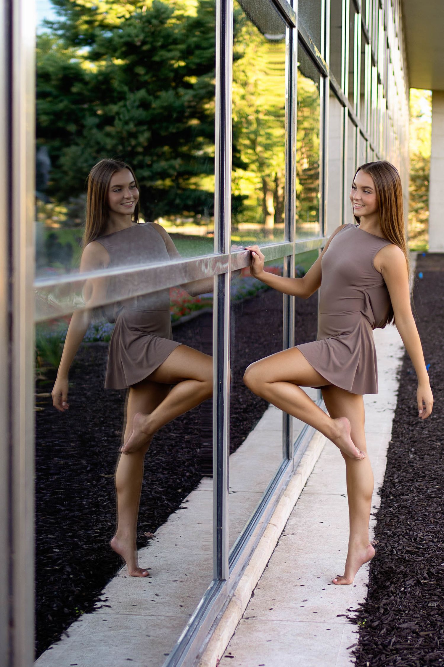 Series of dance poses against reflective glass windows outdoors.