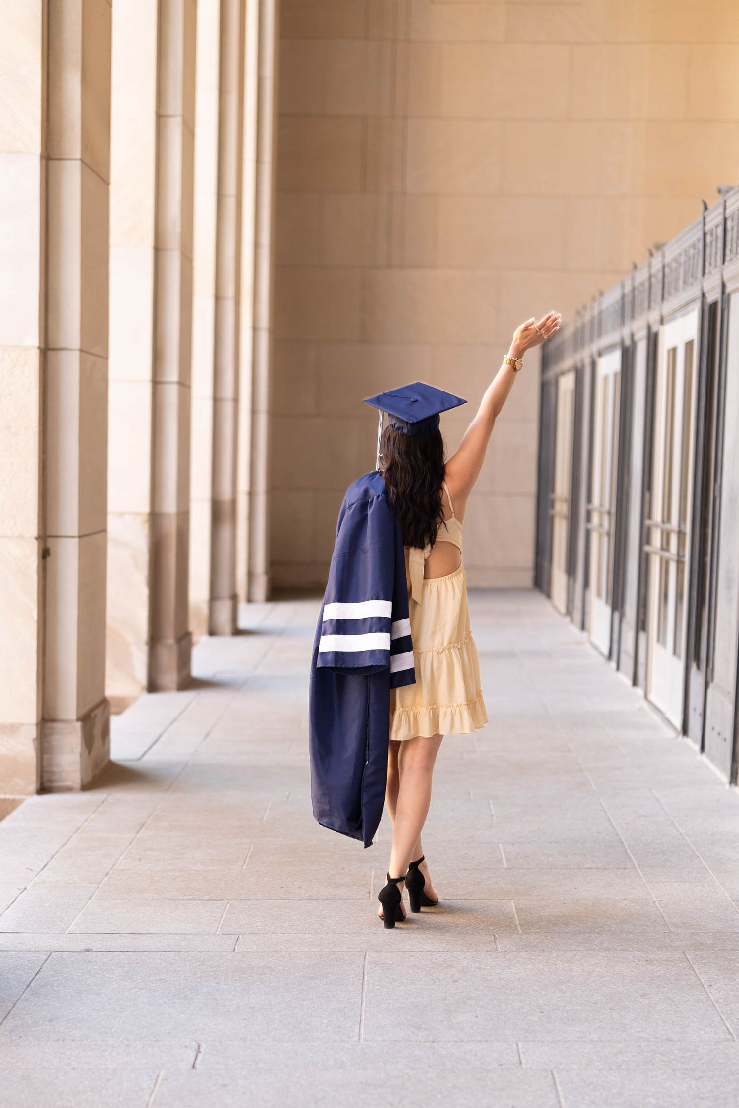 A sequence of photos shows two graduates in caps and gowns dancing joyfully in a covered walkway.