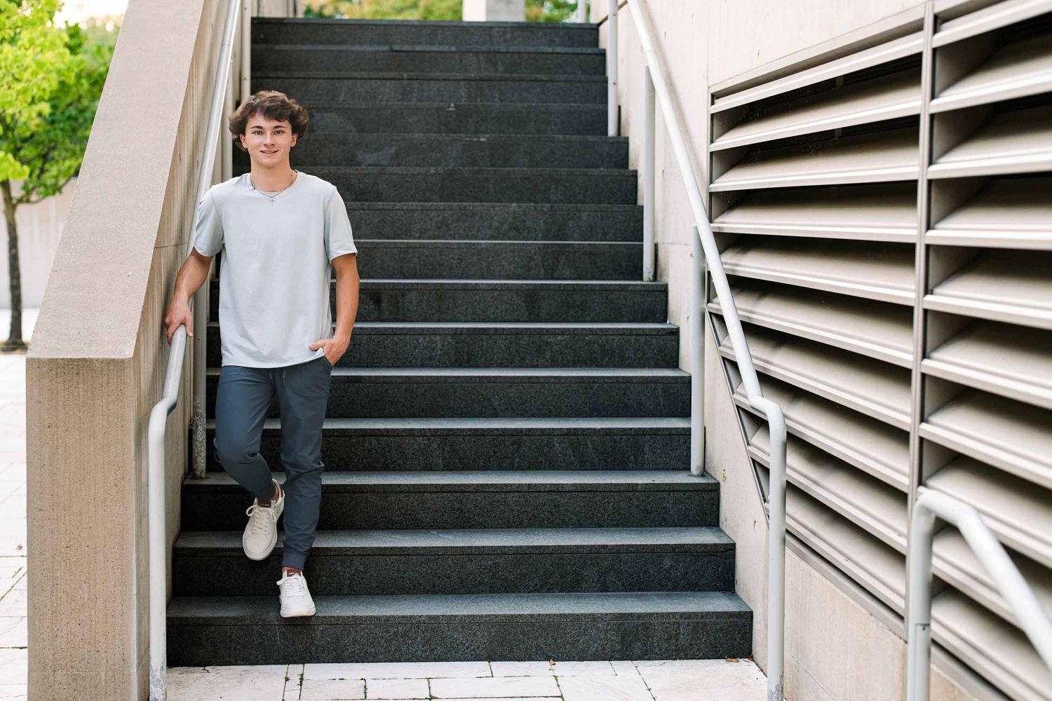Multiple shots of someone walking up modern architectural stairs with geometric patterns.