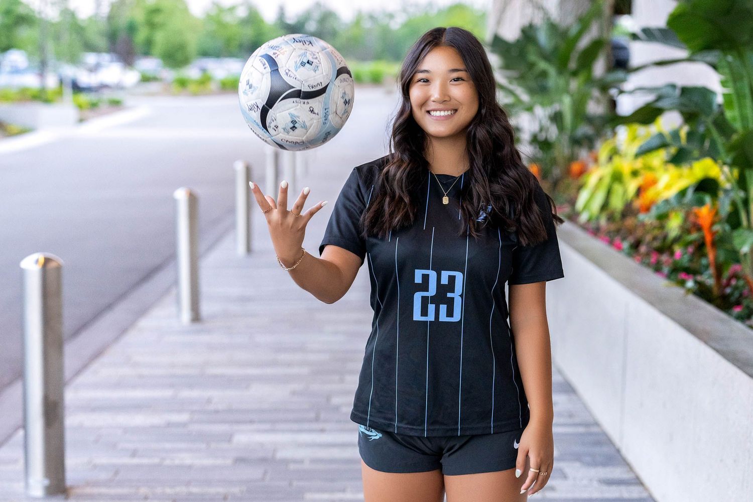Soccer player in jersey demonstrating ball control techniques outdoors.