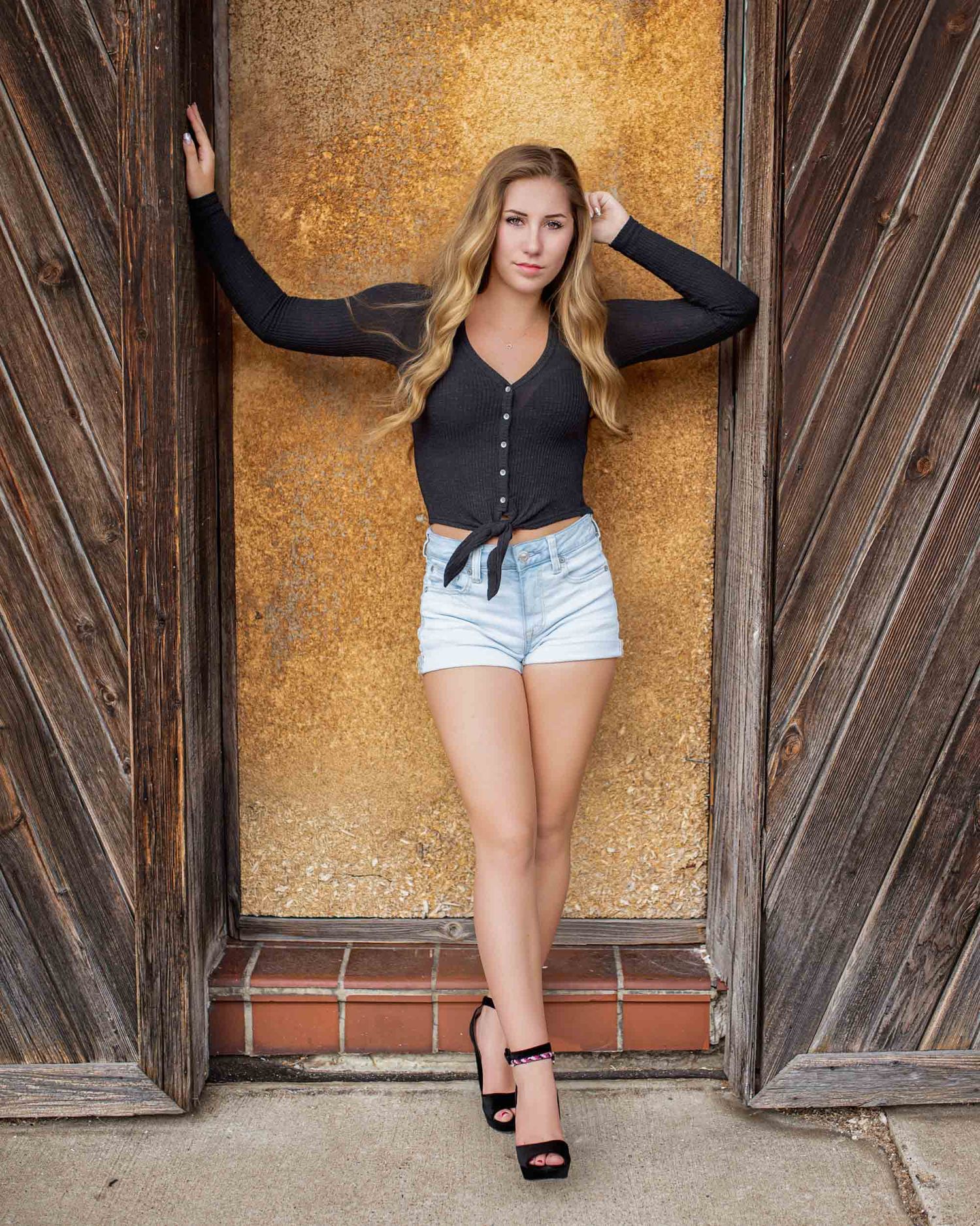Industrial style senior photos in downtown Muskegon with rustic textures and edgy vibes.