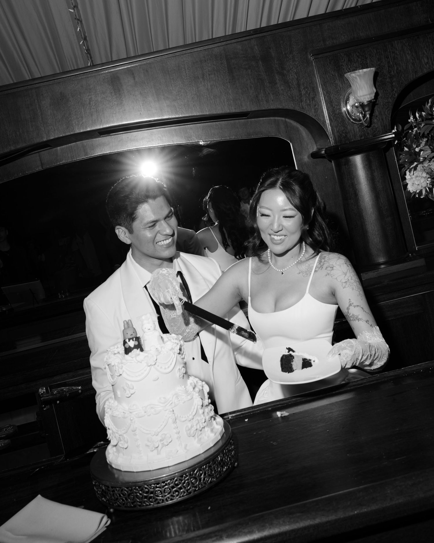 Black and white photo sequence showing people sitting at a table in a dimly lit setting.
