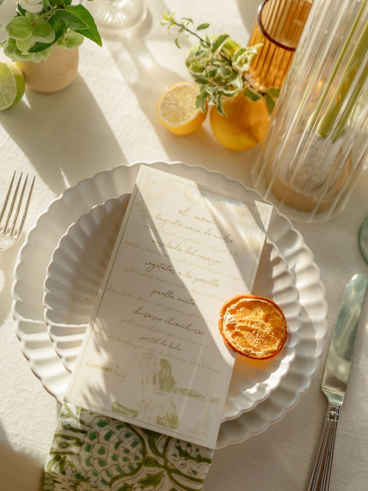 Elegant place settings with handwritten cards, fresh greenery, and golden accents create a sophisticated tablescape.