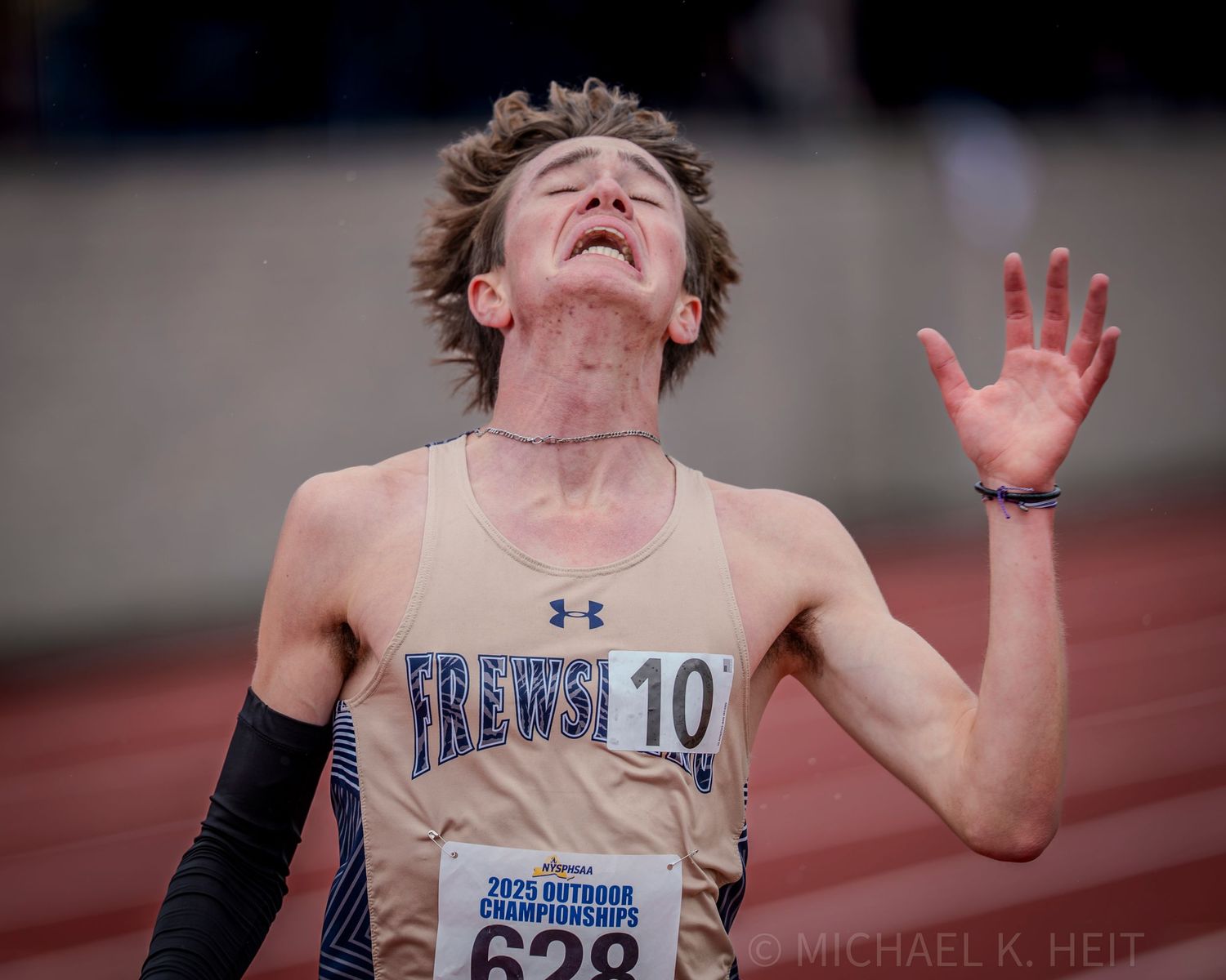 Athletes show intense emotion and determination during a track and field competition.