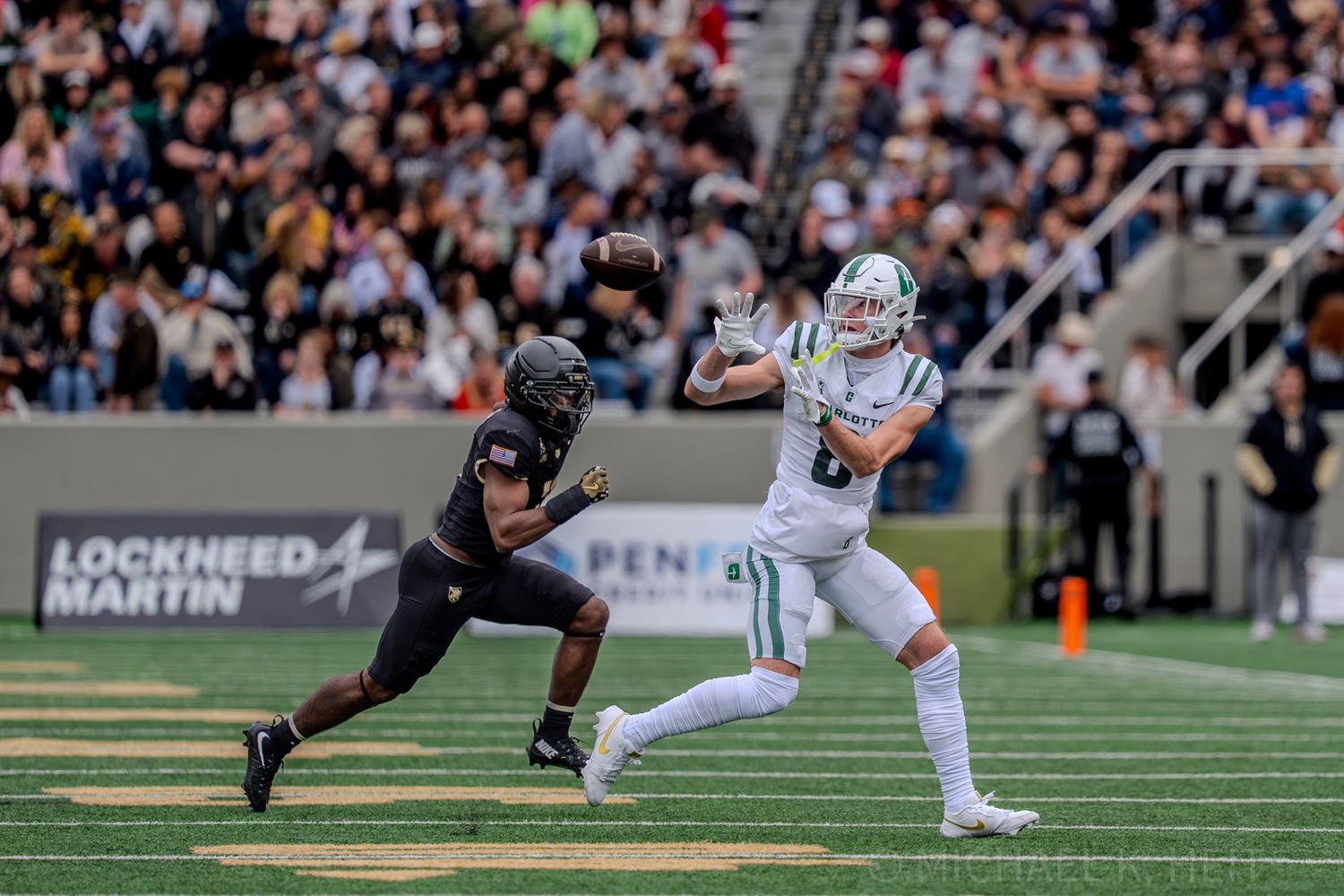 Football players from opposing teams engage in dynamic play on the field.