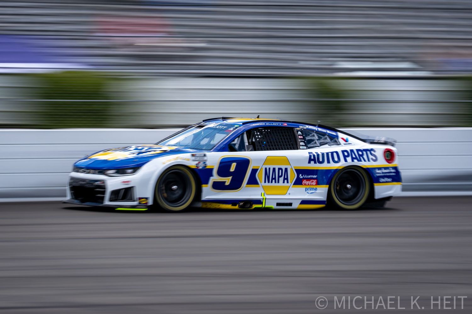 Chase Elliott's No. 9 NAPA Auto Parts NASCAR race car speeding on track during a Cup Series race.