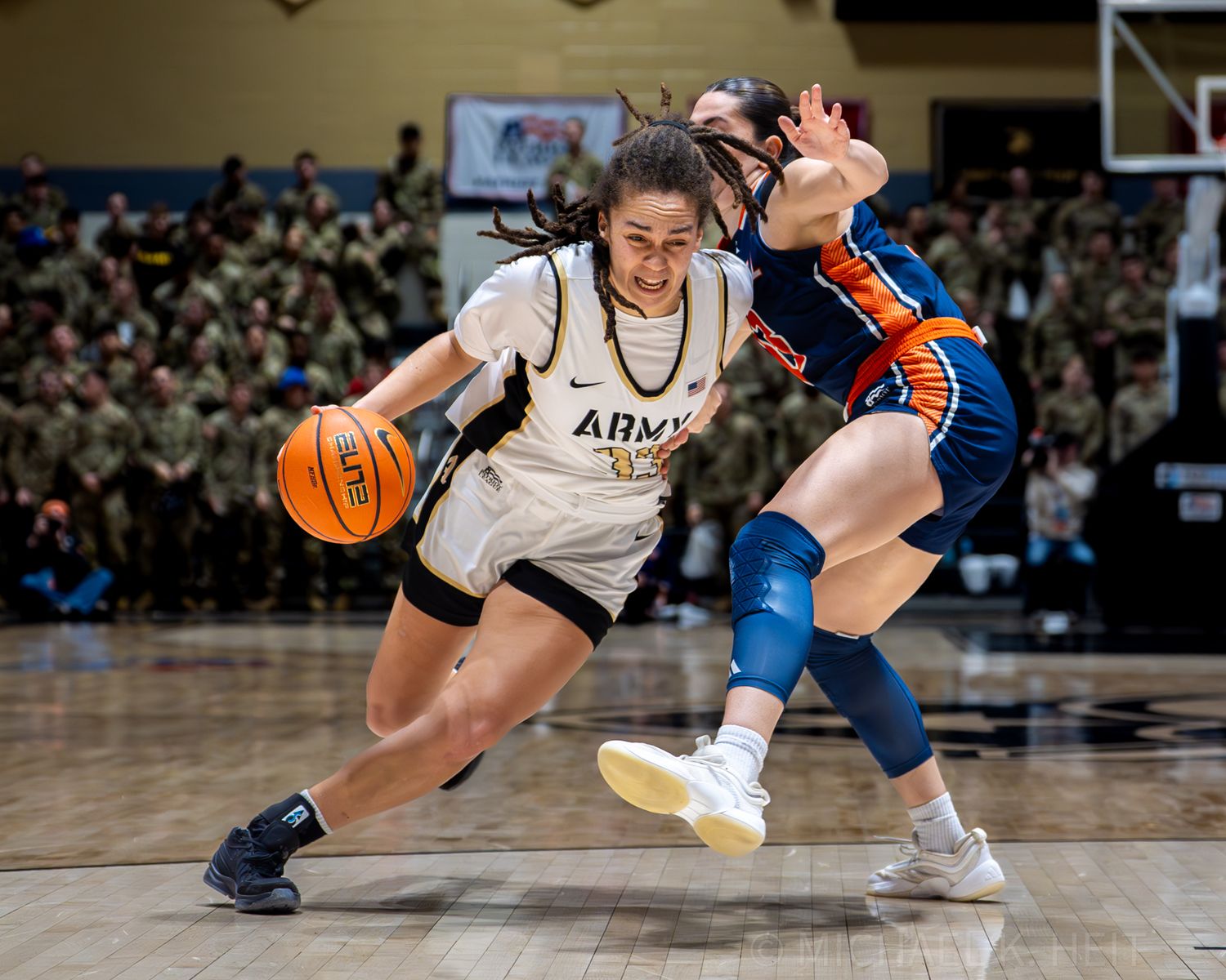 Close-up action shot of basketball players battling for ball possession on the court.