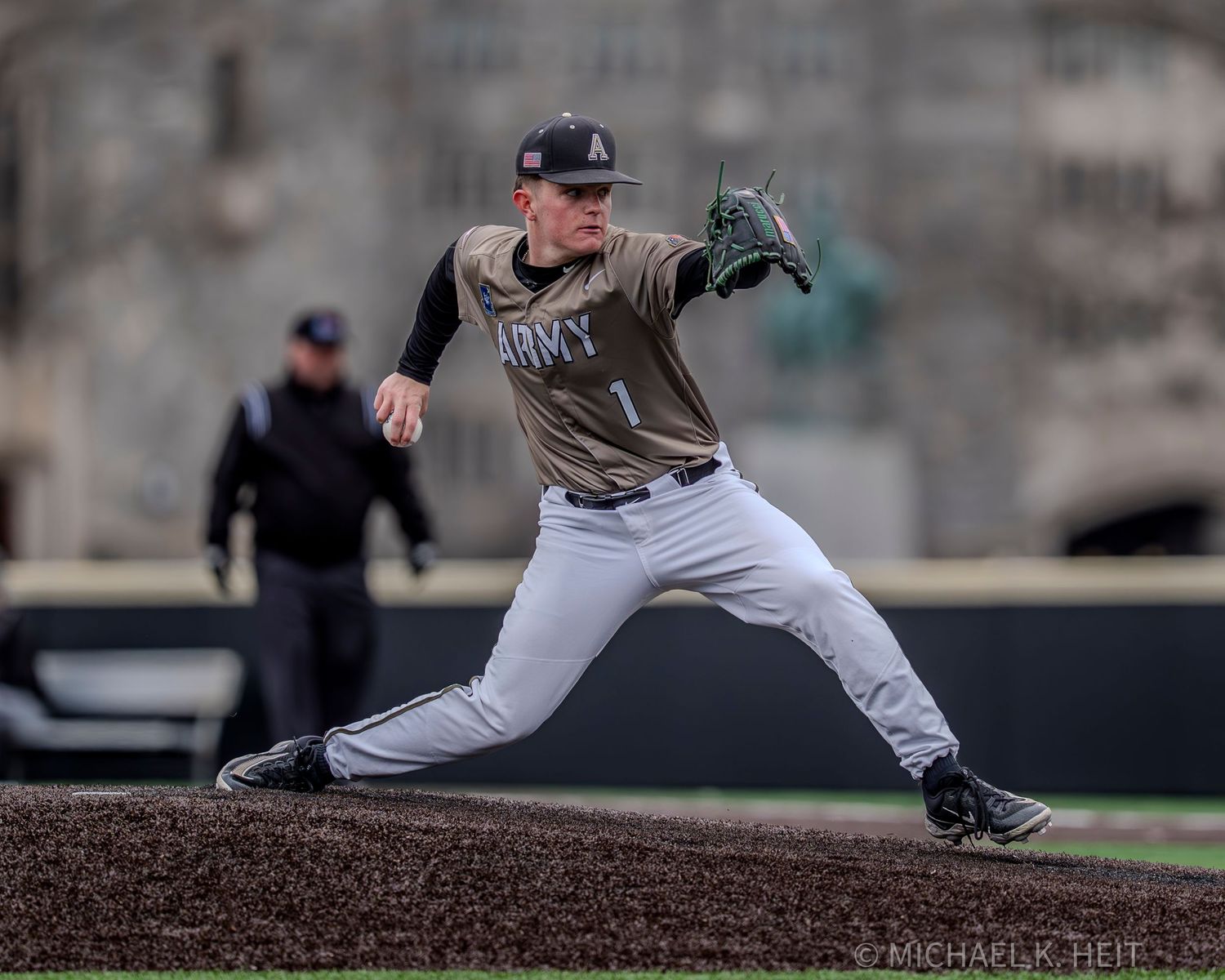 Baseball pitcher on the mound follows through on their delivery during a game.
