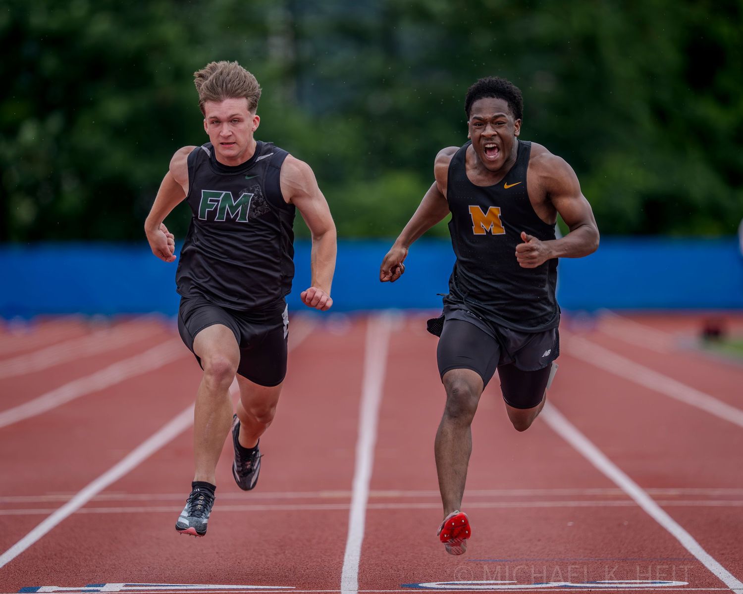 Sprinters burst out of starting positions during an explosive track race start.