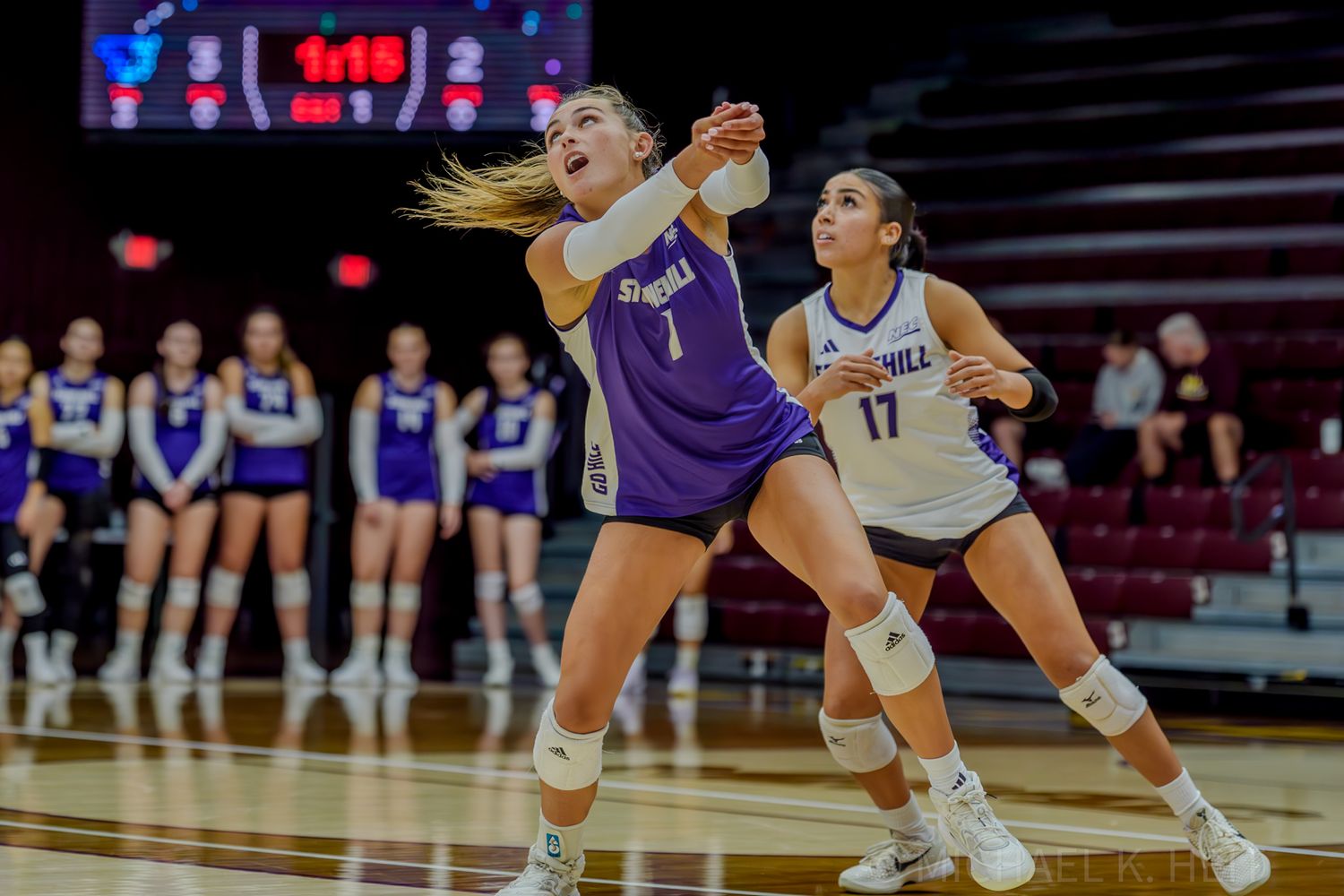 Players diving for the ball during an intense volleyball rally.