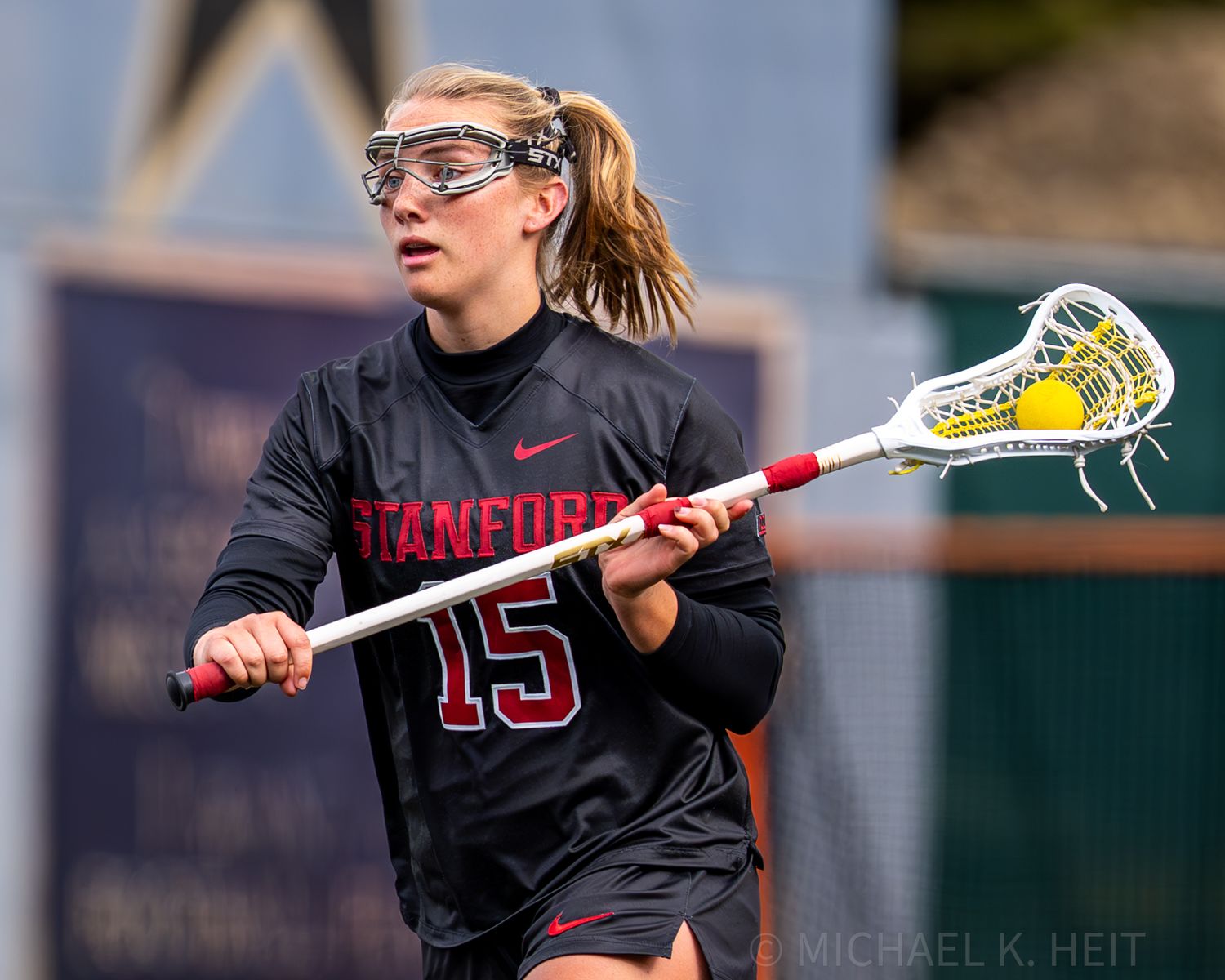 Women's lacrosse players from Stanford and Army compete for the ball during a match.