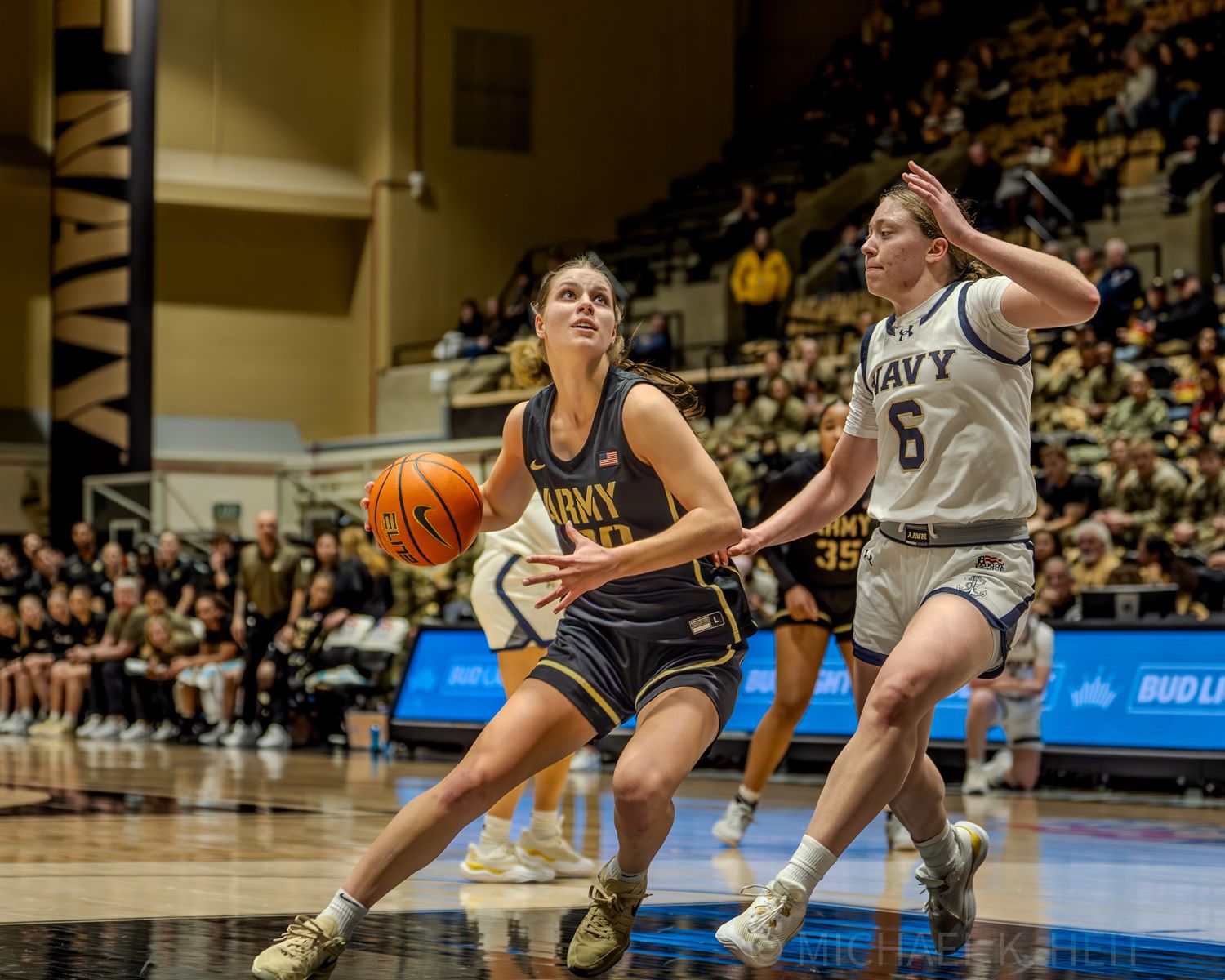 Basketball players from Army and Navy compete for position during a close game.
