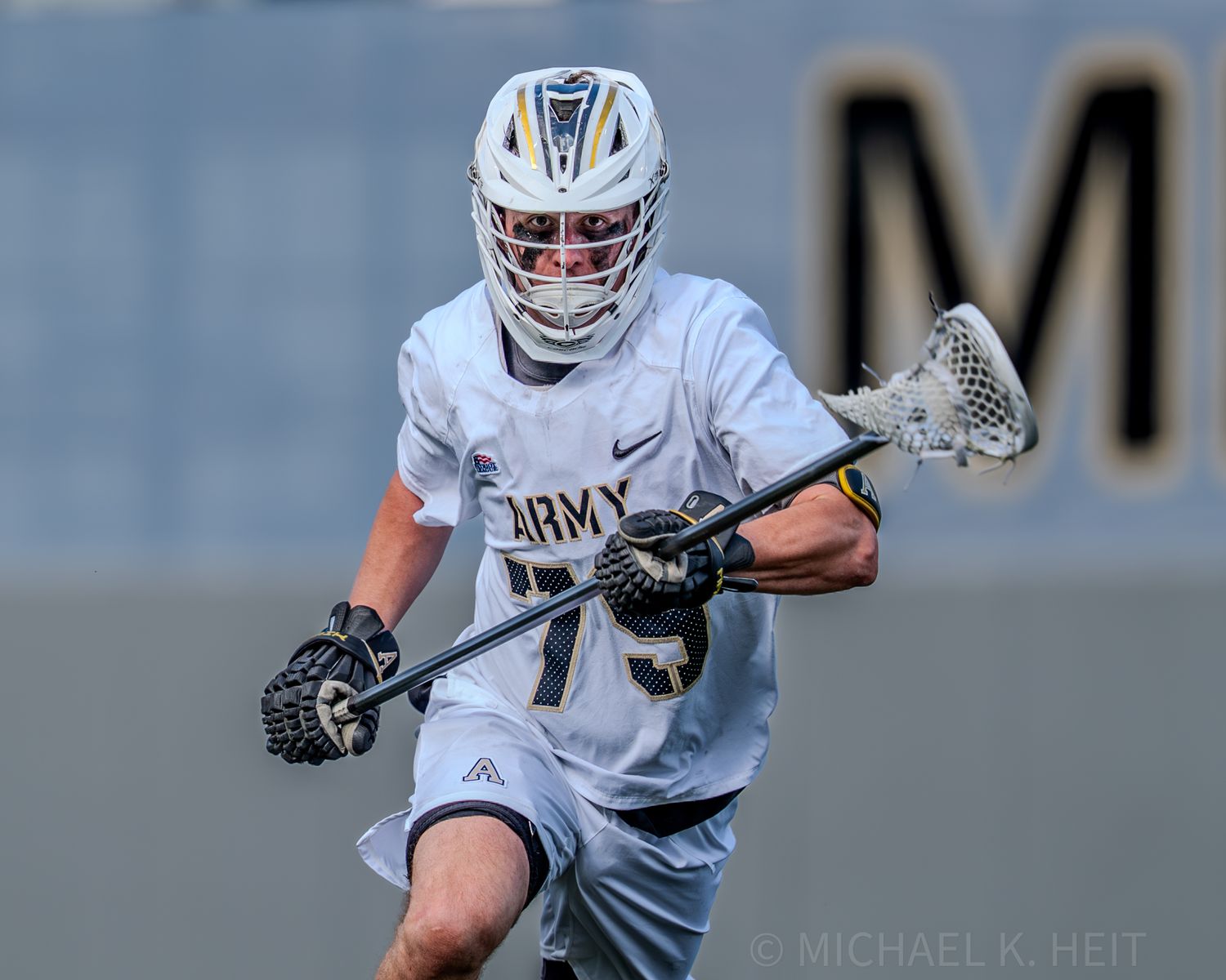 Women's lacrosse players from Army and Stanford compete for possession during an intense match.