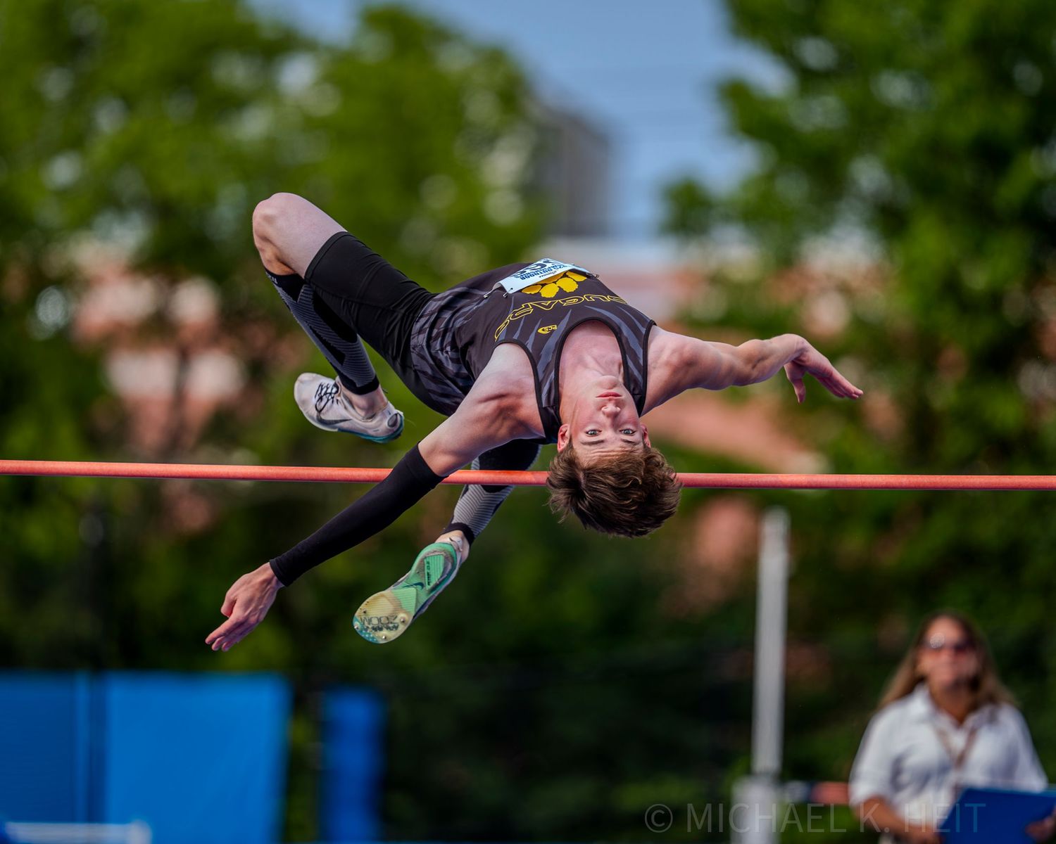 Multiple high jump attempts captured in sequence showing athlete clearing bar.