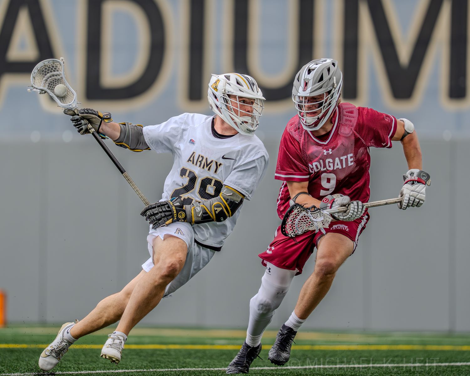 Lacrosse players from Army and Colgate teams battle for control during a match.