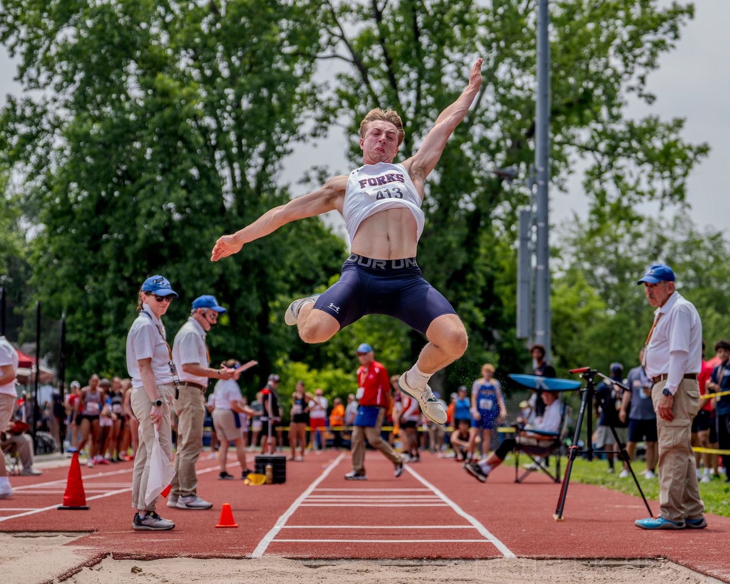 Multiple frames showing track and field athletes performing long jumps on a sunny day.