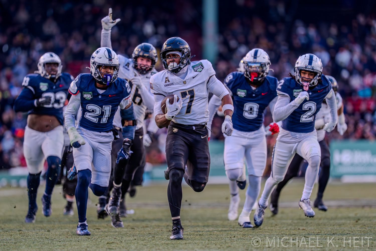 Football players compete in a game sequence showing various plays and tackles on the field during a match.