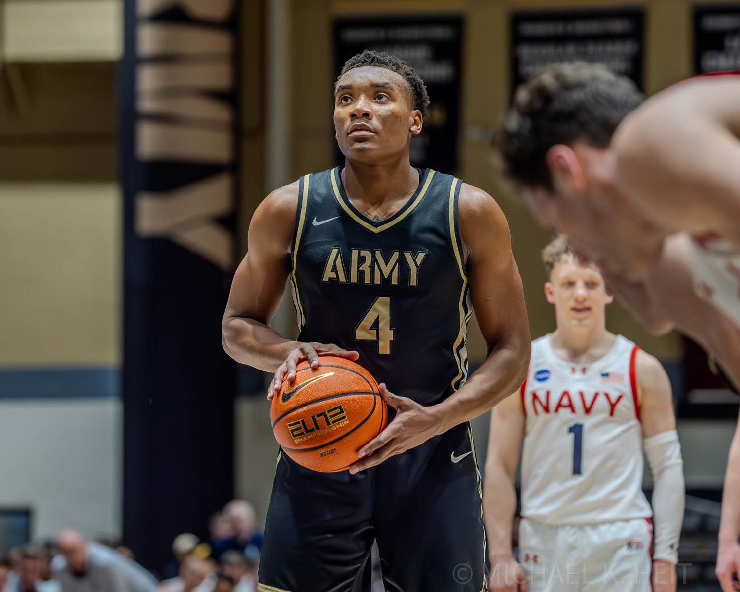 Army and Navy basketball players face off during an intense military rivalry game.