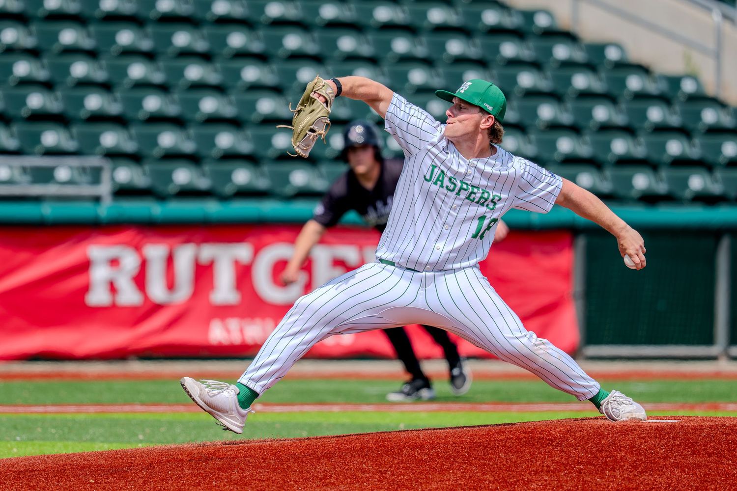 Manhattan Jaspers pitcher delivers a pitch at Rutgers Athletic facility during a college baseball game.