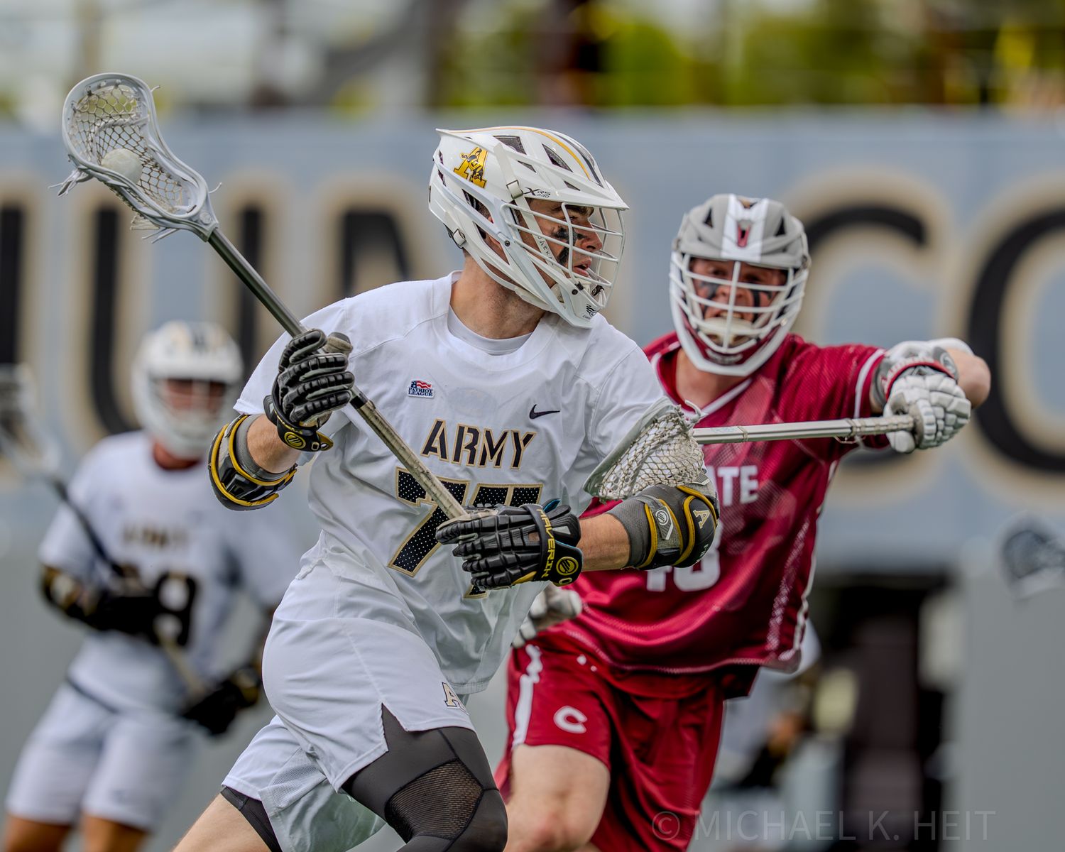 Army and Colgate lacrosse players compete for possession during an intense match.