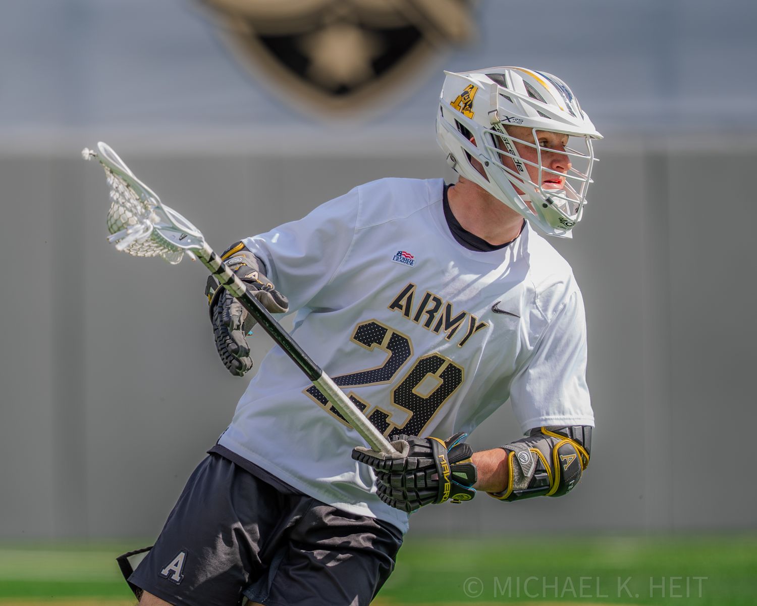 Army lacrosse player making an aggressive offensive move during game action.
