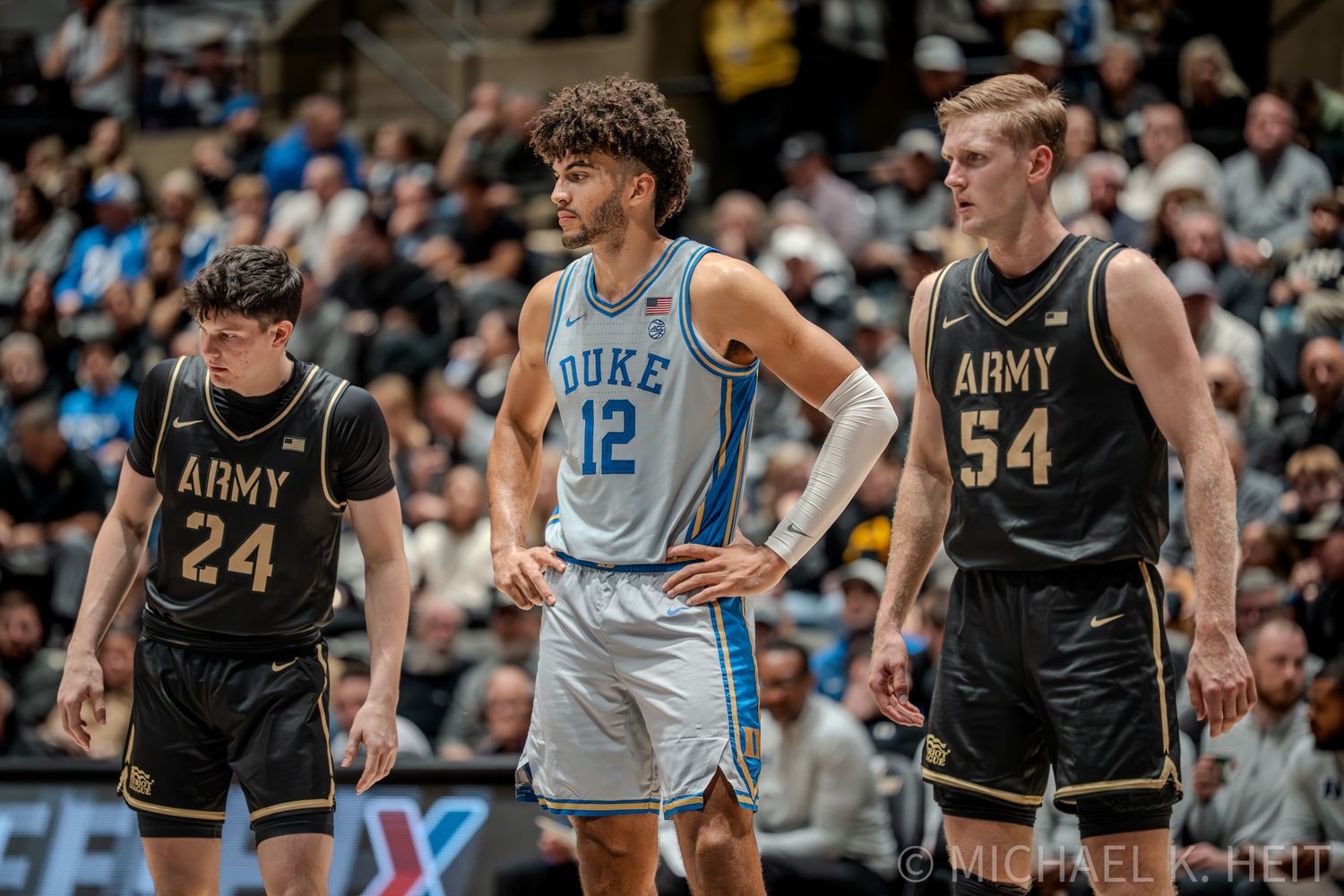 Duke Basketball player Cameron Boozer , and Army Basketball Players compete during an intense match on the court.