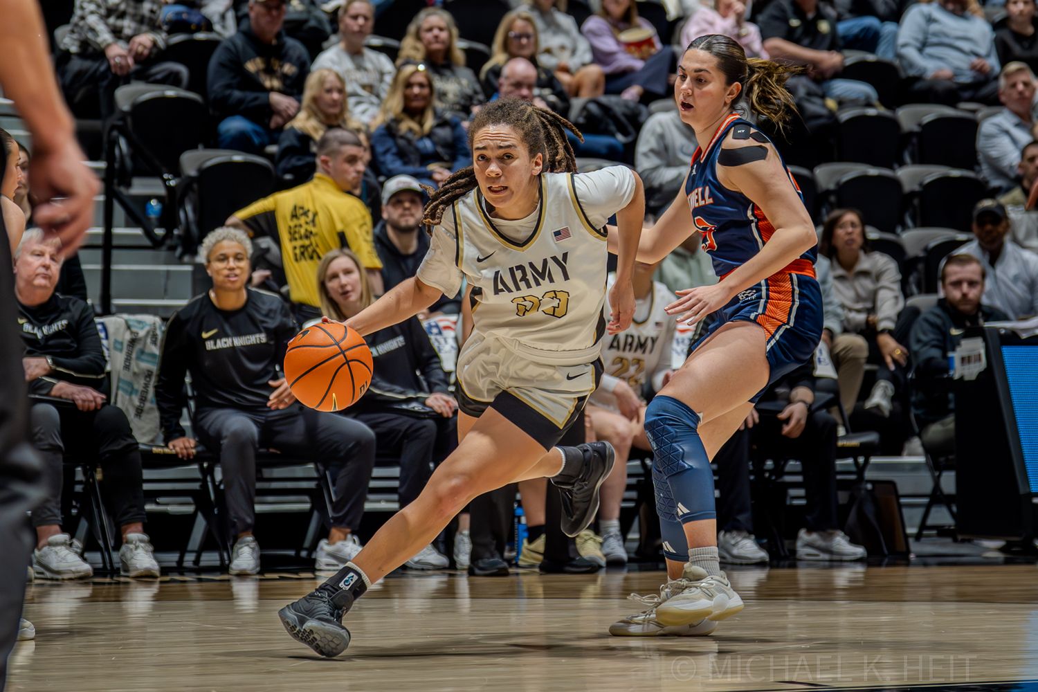 Basketball players in action on a wooden court during an intense game.