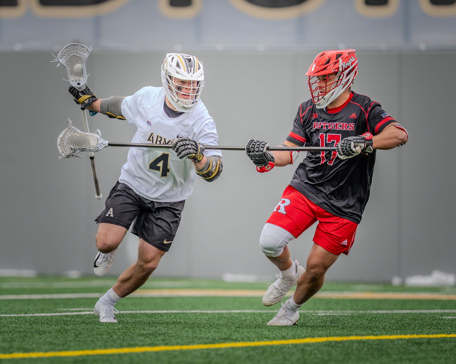Lacrosse players from Army and opposing team compete in dynamic ground play.