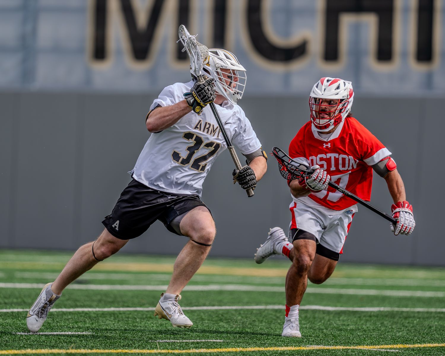 Lacrosse players from Army and opposing team battle for possession on the field.