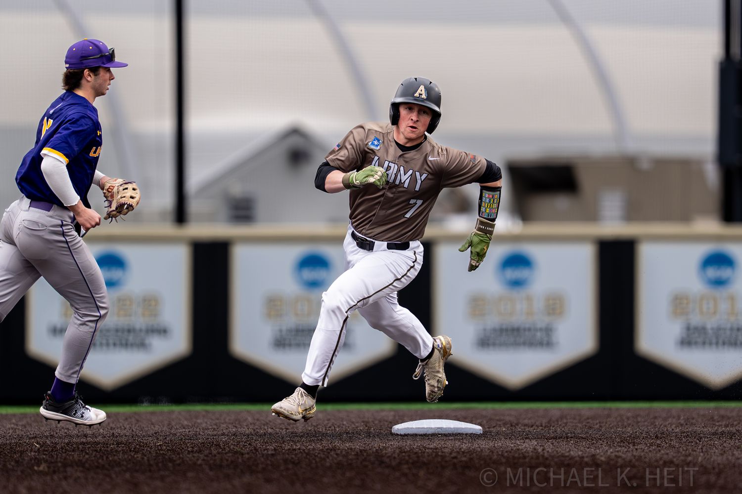 Baseball players demonstrate fielding positions during defensive practice.