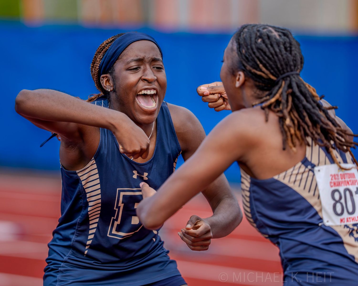 Track team members celebrate together after a successful relay race.