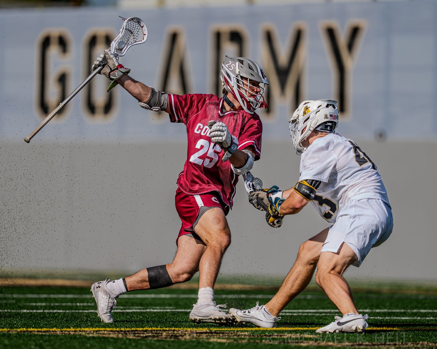 Lacrosse players battle for the ball during a ground play in a competitive match.