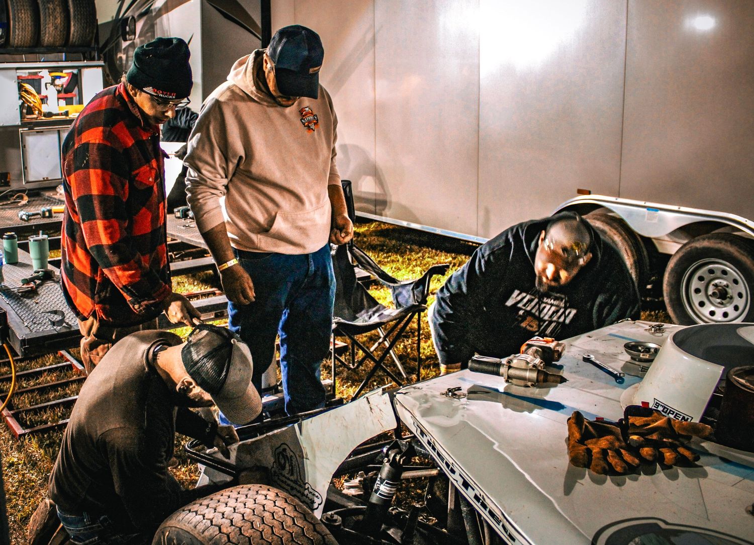 Close-up shots of mechanics working on vehicle repairs in a garage workshop.