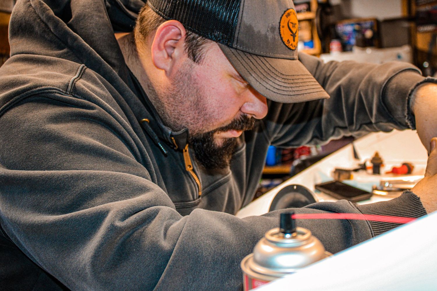 Detailed view of mechanical work being performed in an automotive workshop.