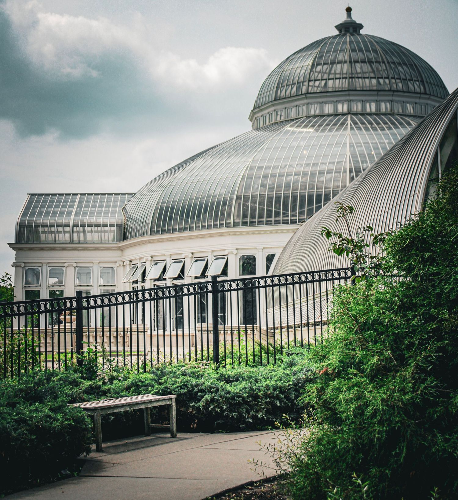 Historic glass conservatory building with domed roof architecture and ornate metalwork details.