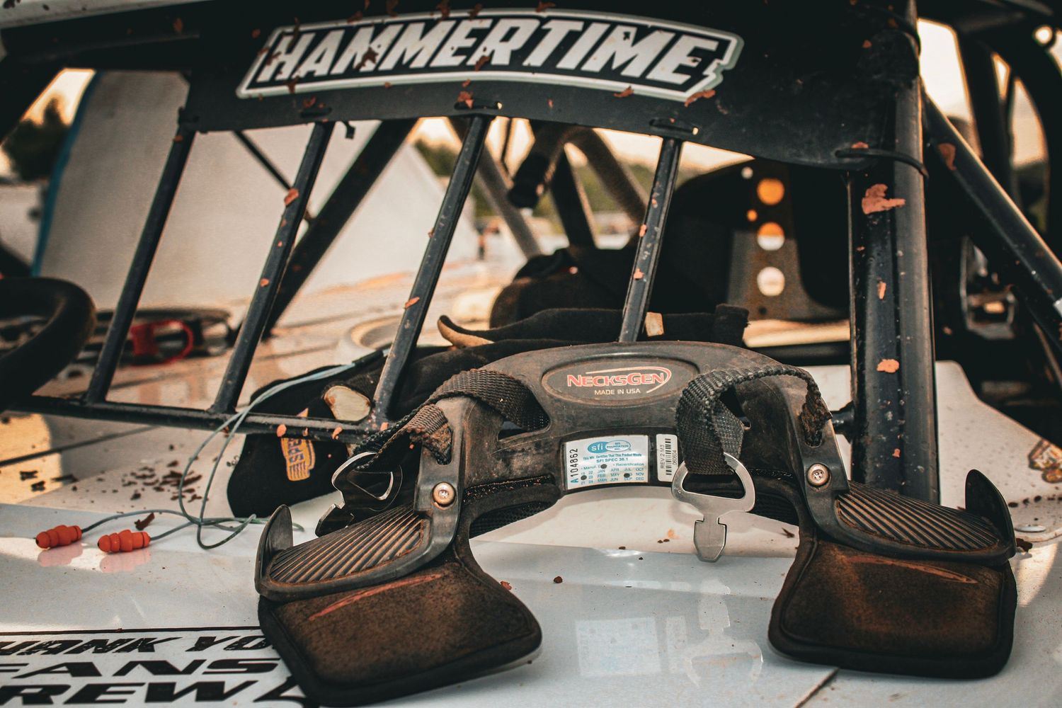 Close-up view of a race car cockpit showing Hammertime branding, digital display and carbon fiber details.