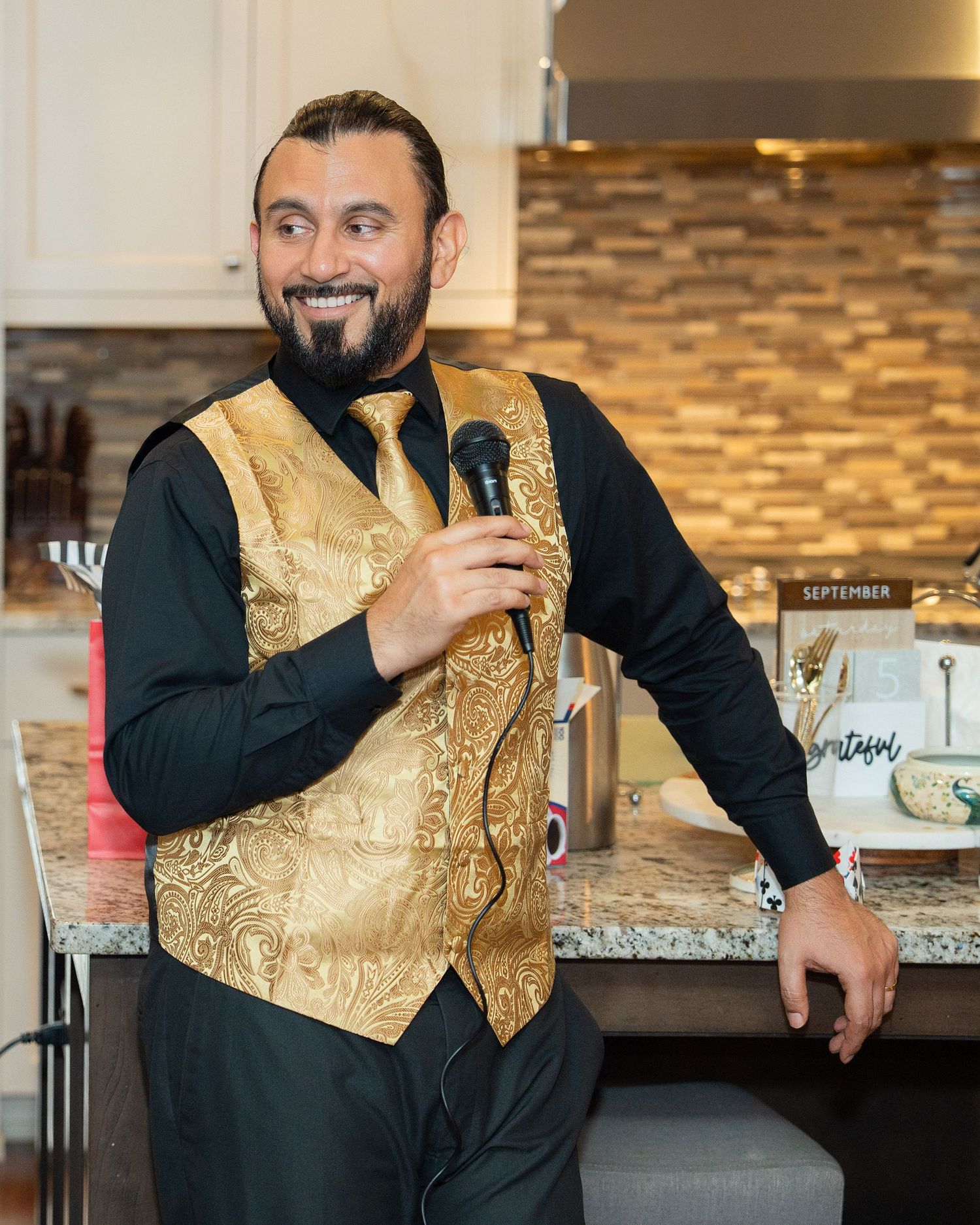 A person in a black suit with gold vest poses in a restaurant interior showing different angles and expressions.