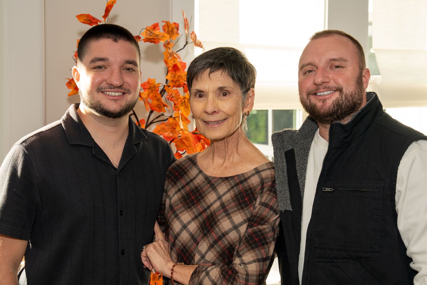 A collage of six photos showing people posing together in casual attire with autumn decorations in the background.