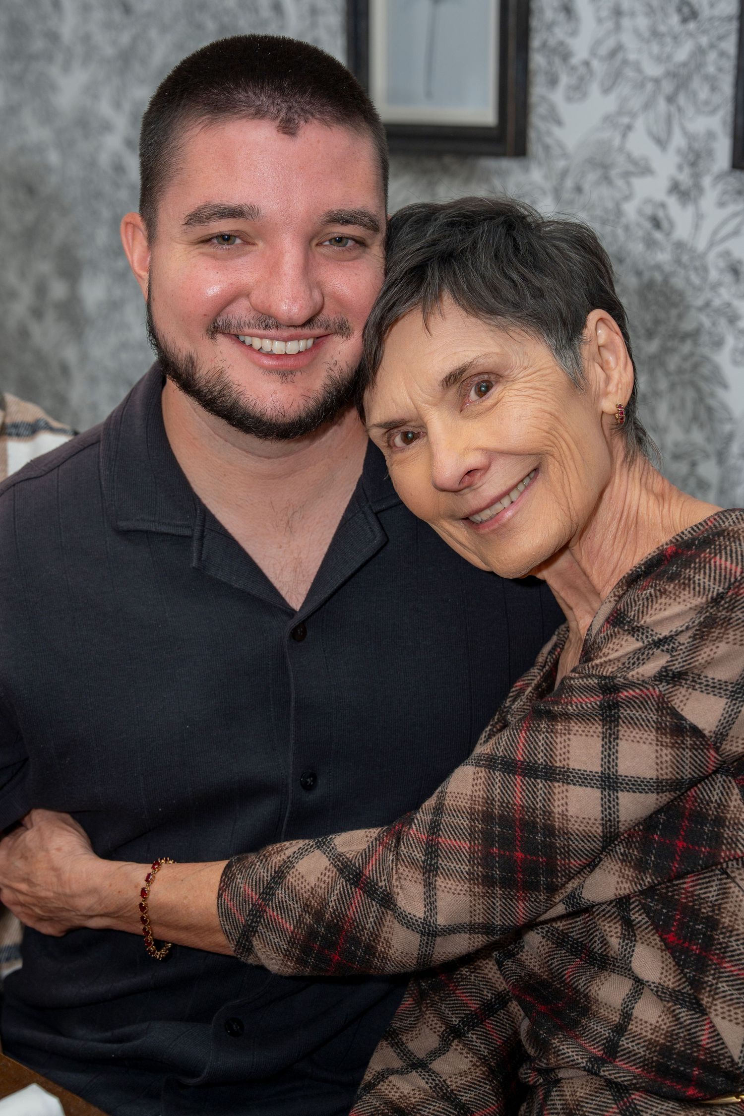 A heartwarming series of photos showing a young man in black and an elderly woman in plaid sharing tender embraces.