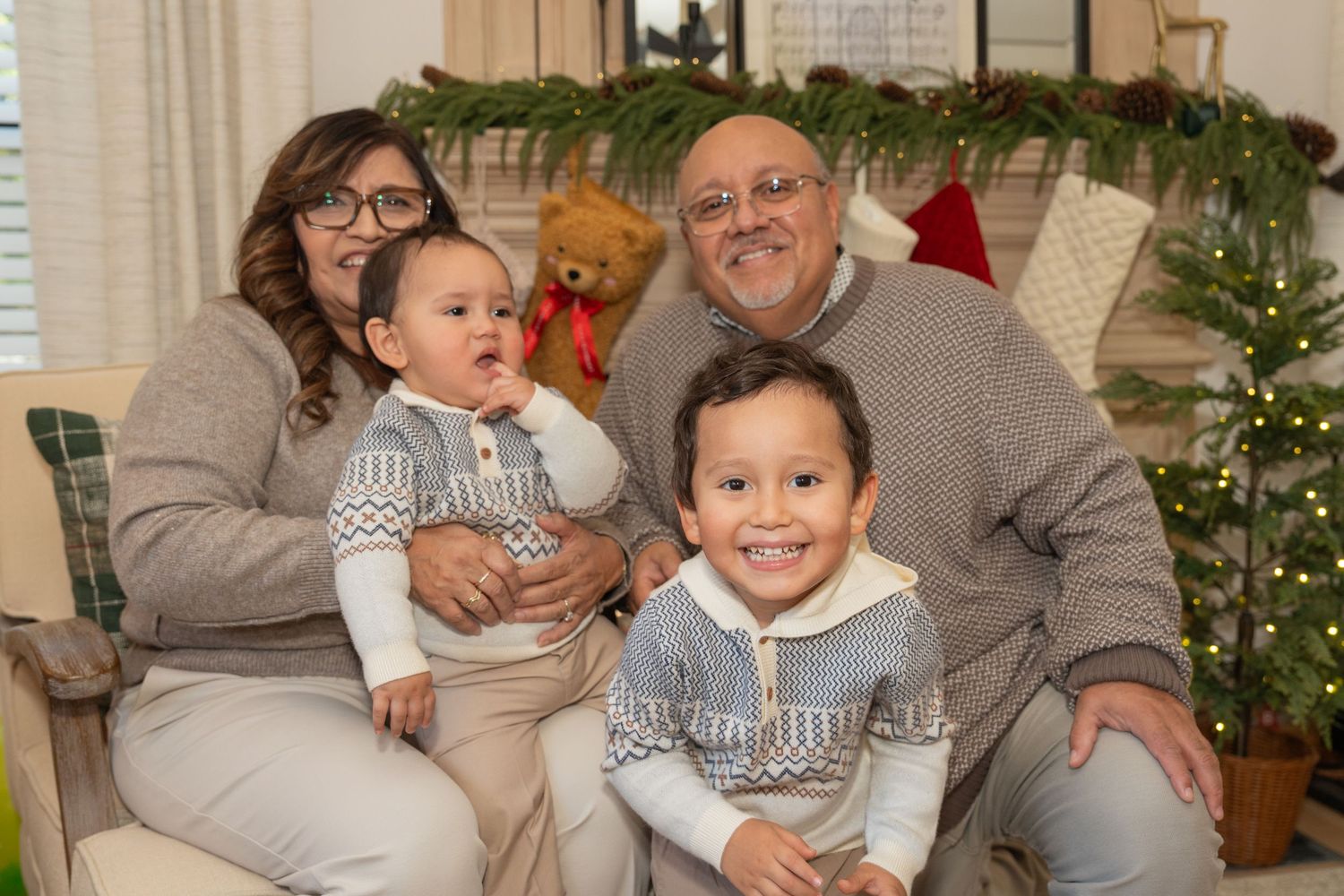 Cozy indoor family gathering with people relaxing on furniture surrounded by holiday decorations.